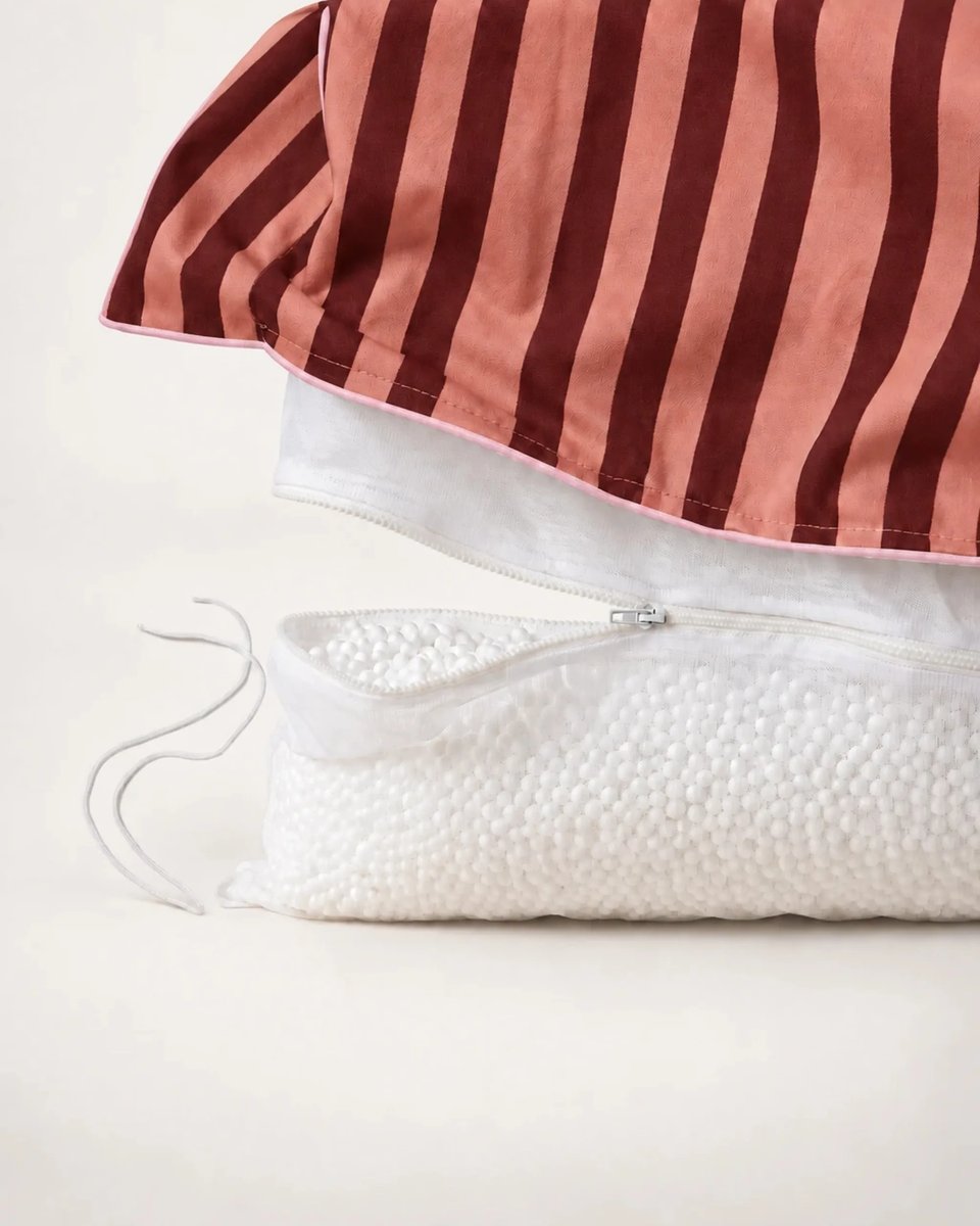 Striped outer cover lifted to show the separate inner bead bag