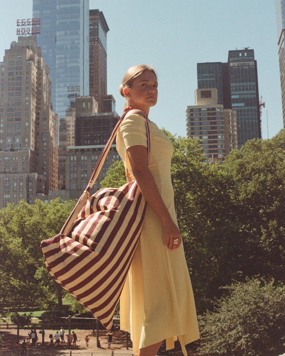 Pier 55 backrest carried over the shoulder in Central Park, Manhattan skyline behind