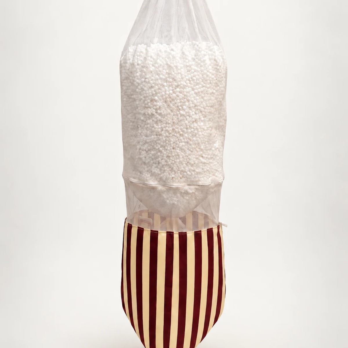 The striped cover lifted to show the inner bag of beads