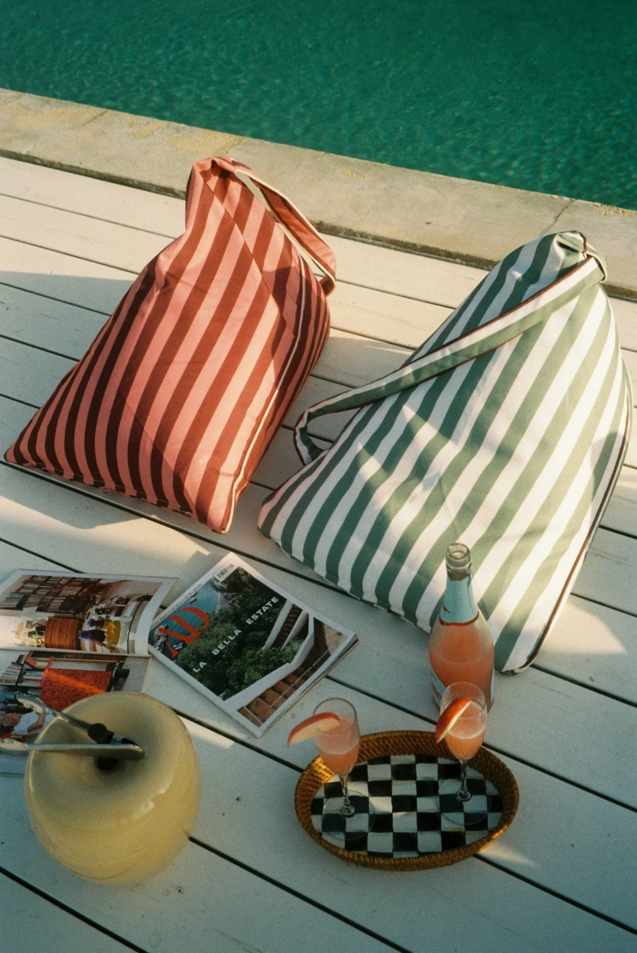LIELOW striped bags poolside on a wooden deck