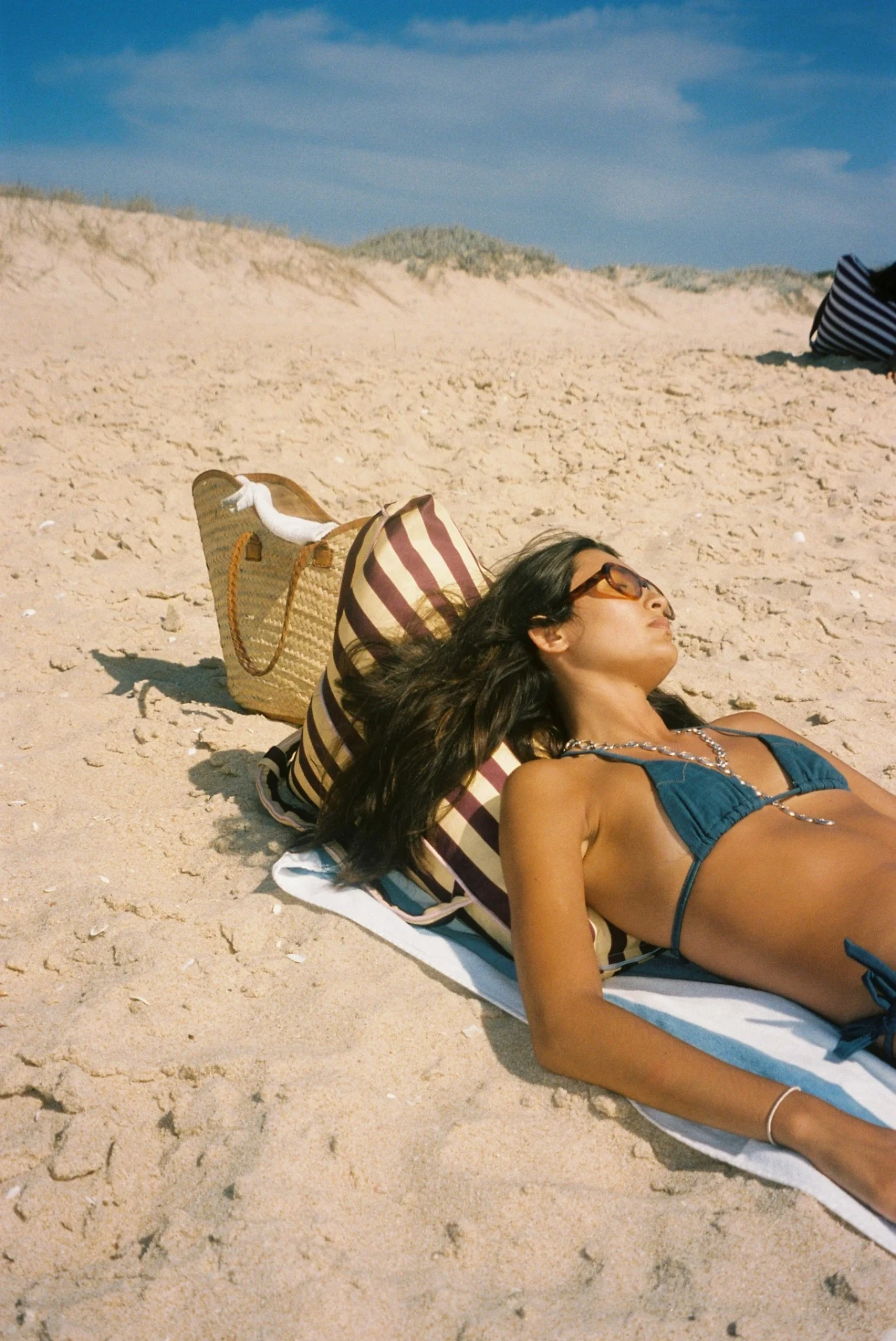 Sunbathing on the beach leaning on a LIELOW bean bag