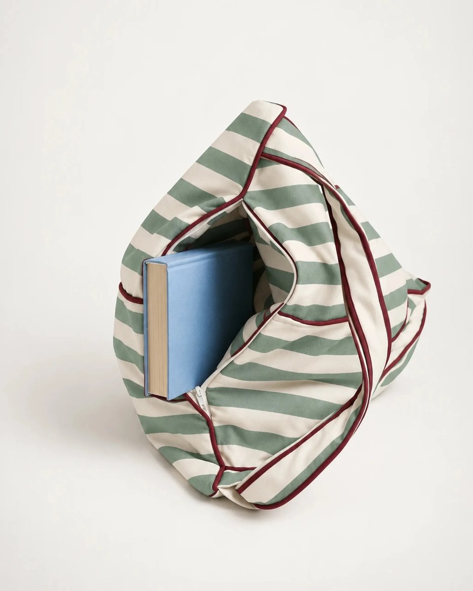 Open storage compartment of the Tribeca backrest holding a hardcover book