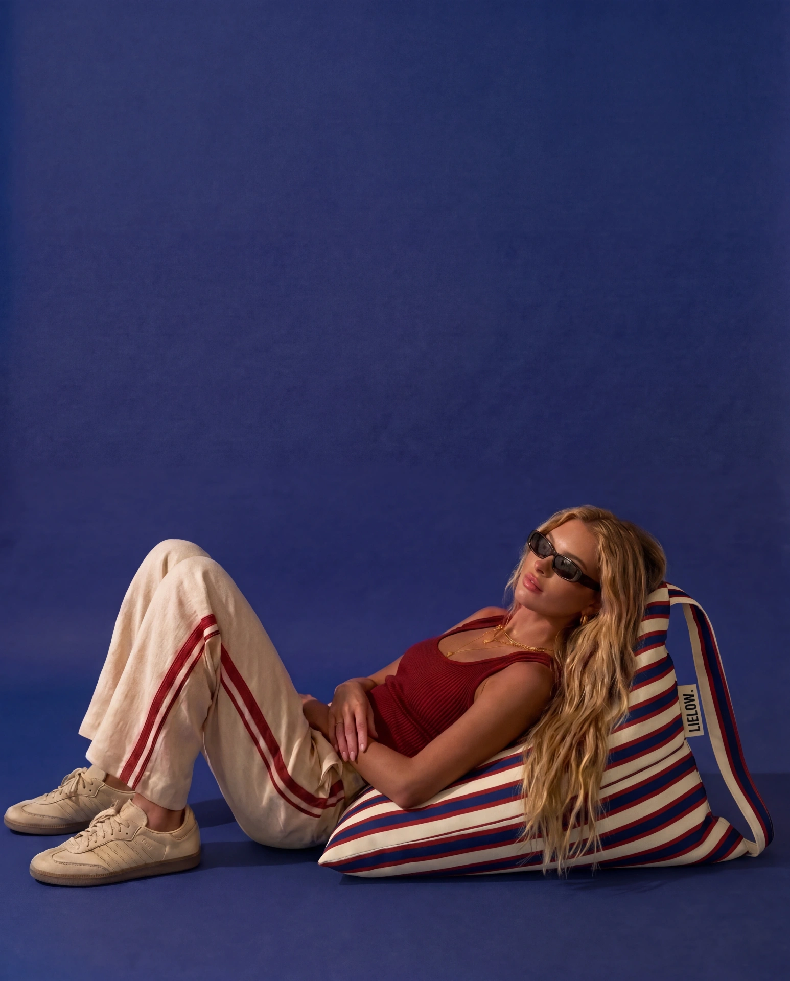 LIELOW Montauk — model lounging on striped bag-chair against blue backdrop